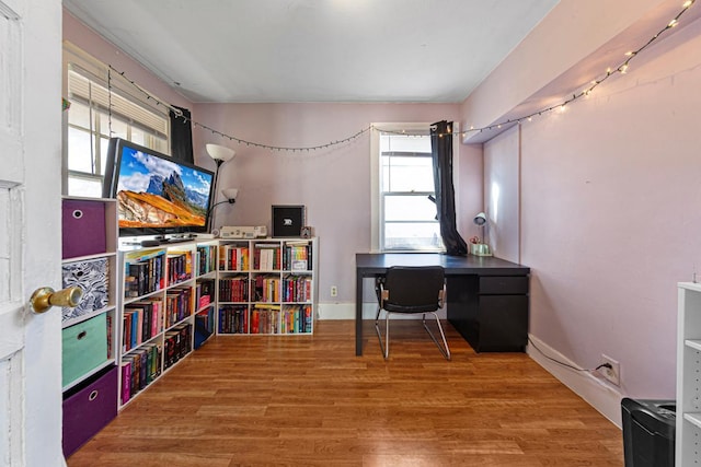 home office with wood finished floors and baseboards