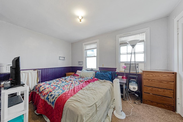 bedroom with carpet floors, wainscoting, and cooling unit