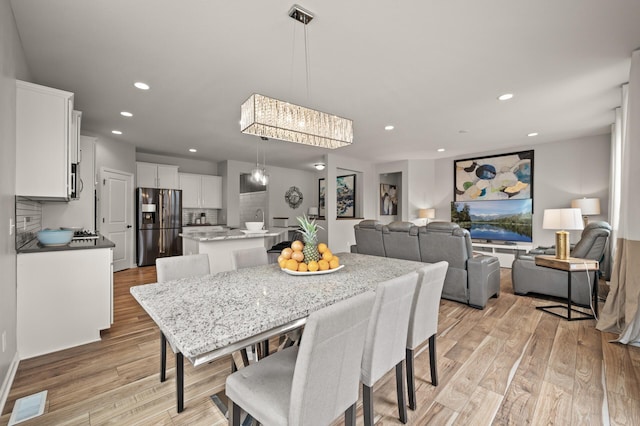 dining area with recessed lighting, visible vents, and light wood-style floors