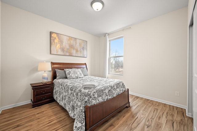 bedroom featuring wood finished floors and baseboards