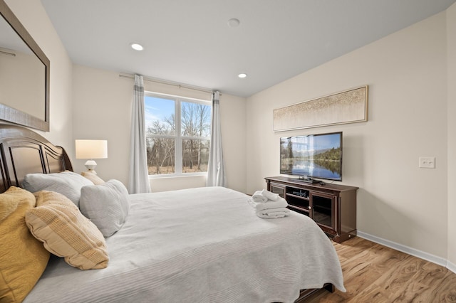 bedroom with recessed lighting, baseboards, and light wood-style floors