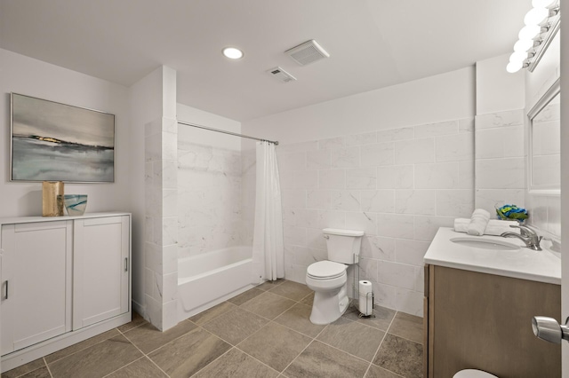 bathroom with vanity, toilet, shower / bath combo, and visible vents