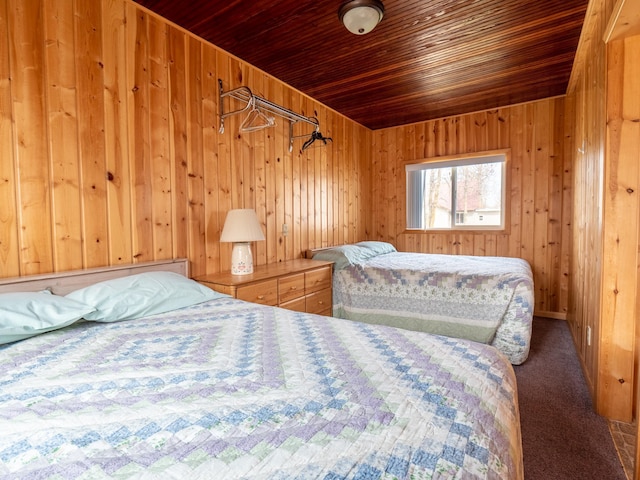 bedroom with wood walls, wooden ceiling, and carpet flooring