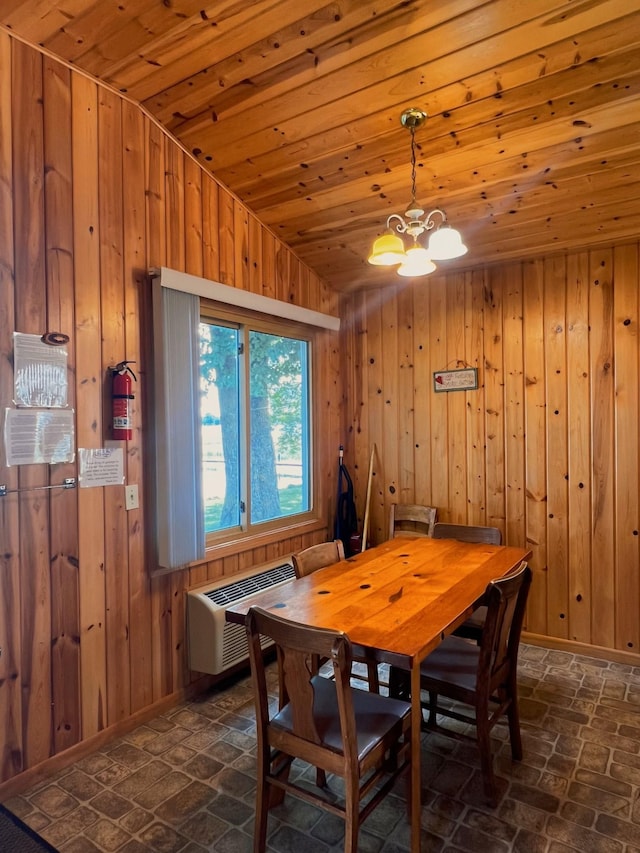 dining area with wooden ceiling, wooden walls, a notable chandelier, and a wall mounted AC