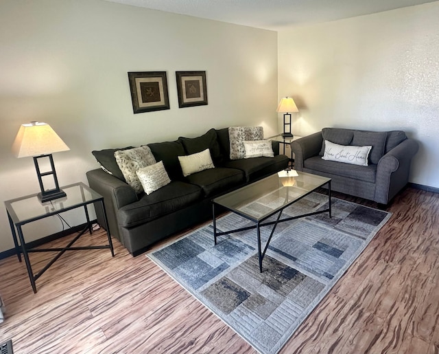 living room featuring baseboards and wood finished floors