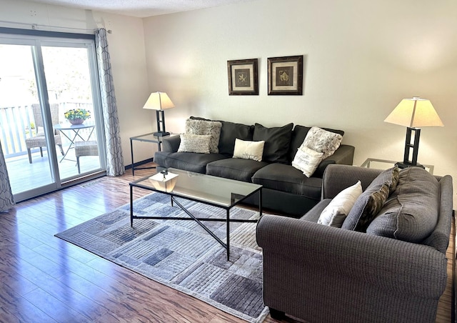 living room with a textured ceiling and wood finished floors