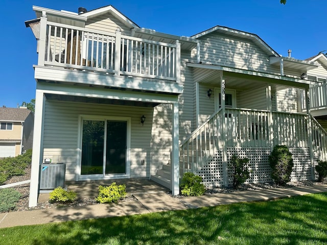 rear view of house featuring central AC unit