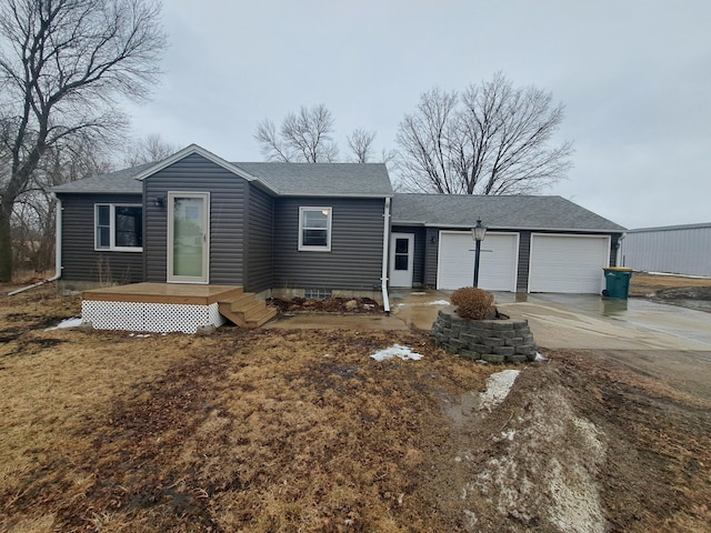 ranch-style house with a garage, a shingled roof, and concrete driveway