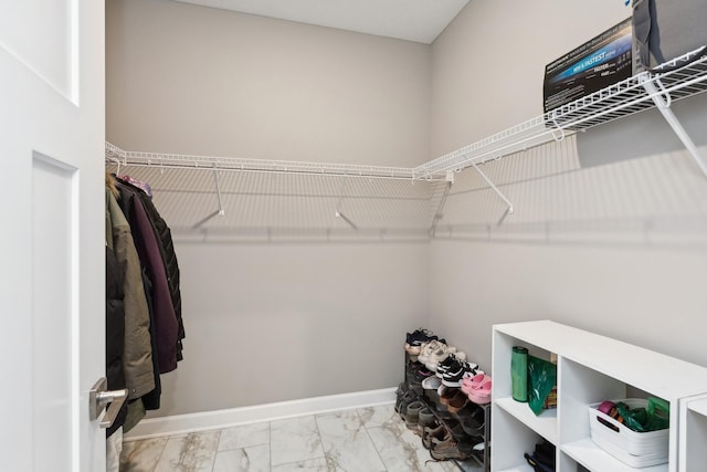 spacious closet featuring marble finish floor