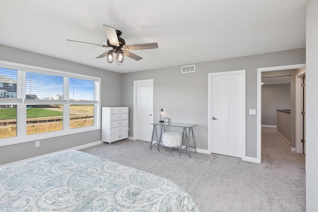 bedroom featuring a ceiling fan, carpet, visible vents, and baseboards