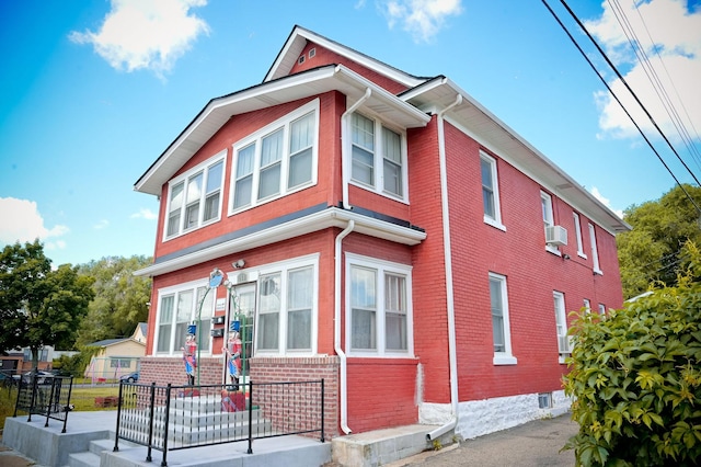 view of side of home with brick siding