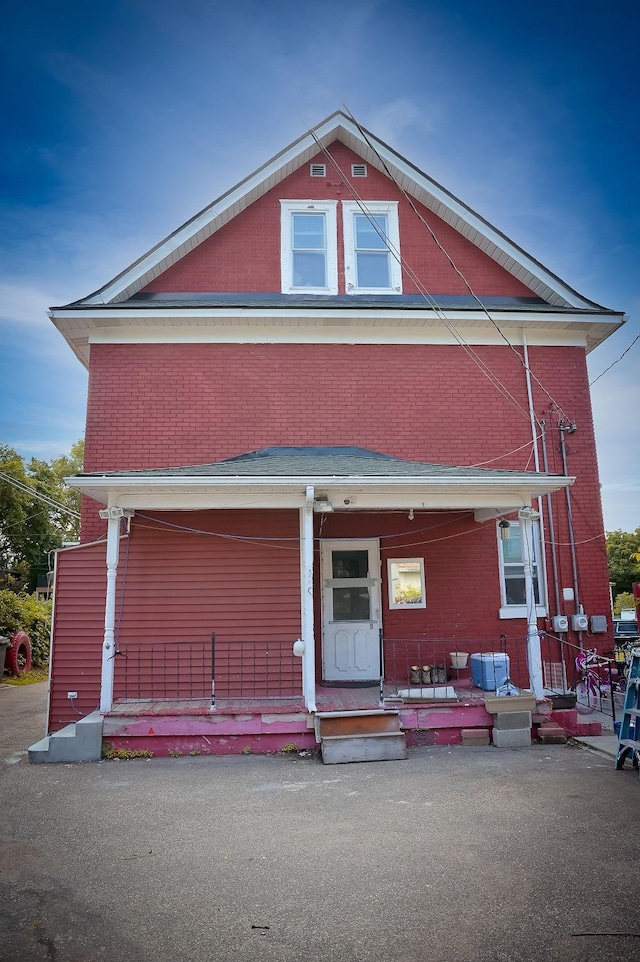 view of front facade featuring a porch and brick siding