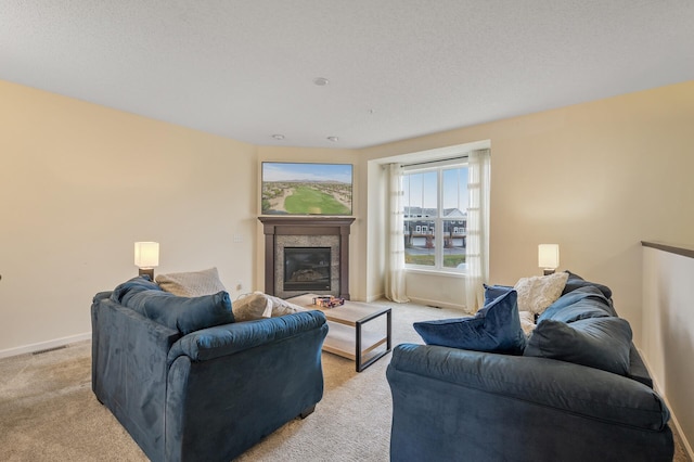 living room with light carpet, baseboards, visible vents, and a glass covered fireplace