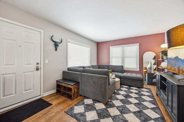 living room with baseboards and light wood finished floors