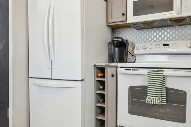 kitchen with white appliances, light countertops, and backsplash