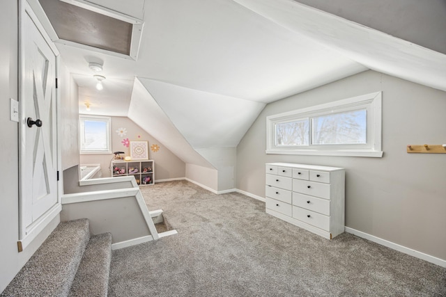 bonus room with lofted ceiling, carpet floors, and baseboards