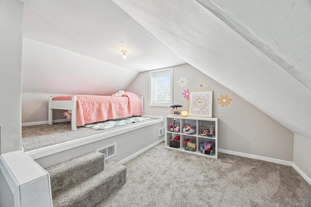 bedroom with lofted ceiling, carpet floors, visible vents, and baseboards