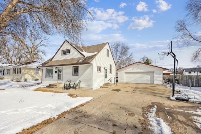 view of front of home with entry steps, a garage, roof with shingles, an outbuilding, and fence