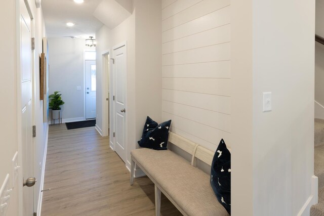 mudroom featuring light wood-style flooring and baseboards