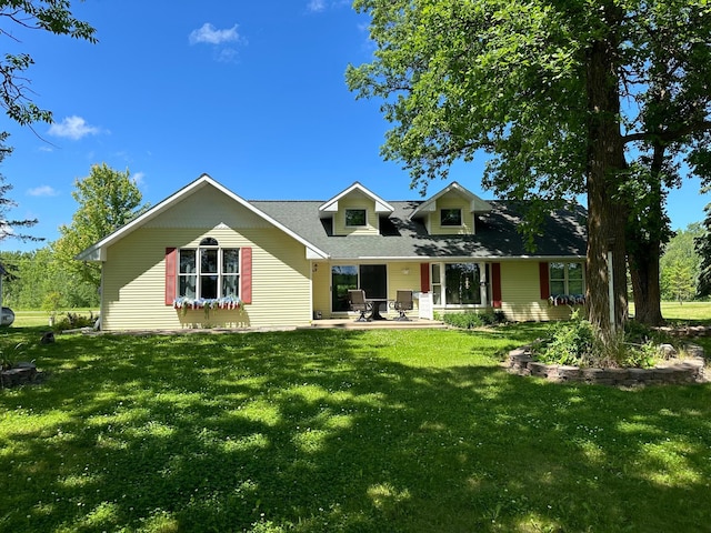 view of front of house featuring a front lawn and a patio area