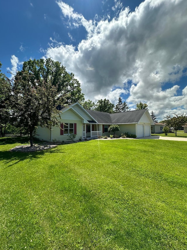 ranch-style home featuring a front lawn, driveway, and an attached garage