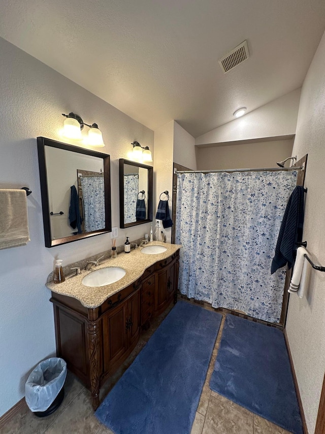 bathroom with lofted ceiling, visible vents, a sink, and a shower with shower curtain