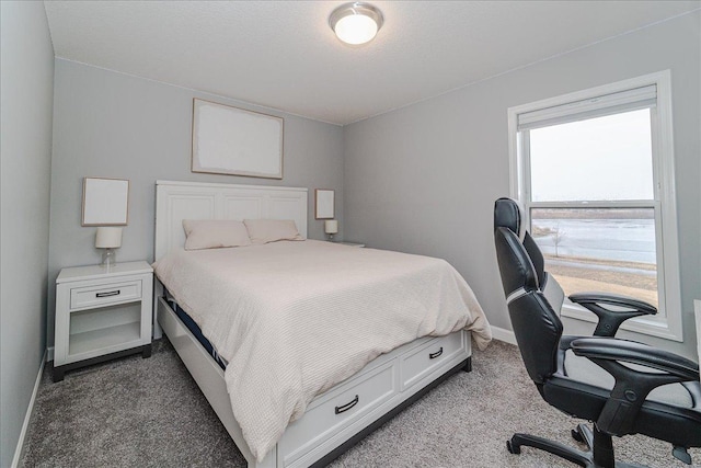 bedroom with carpet floors and baseboards