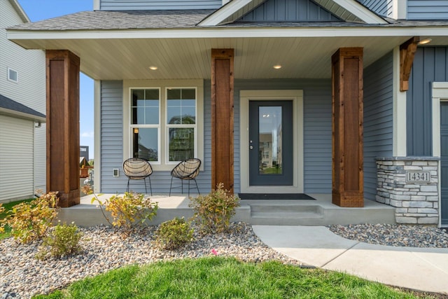 property entrance with a porch, board and batten siding, and roof with shingles