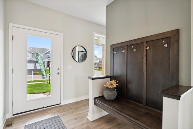 interior space with visible vents, baseboards, and wood finished floors