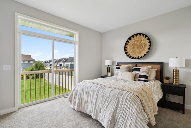 carpeted bedroom featuring access to exterior, a residential view, and baseboards