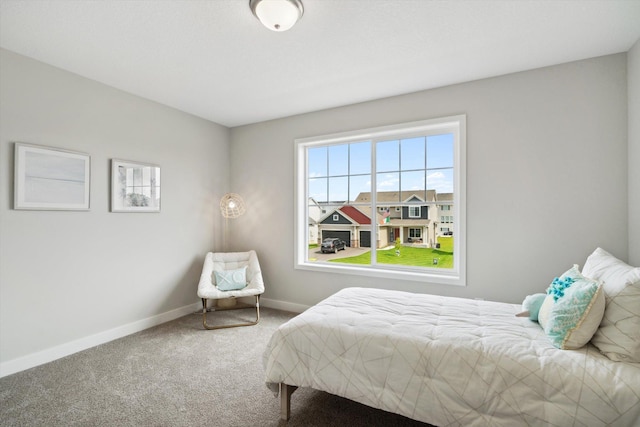 bedroom featuring baseboards and carpet flooring