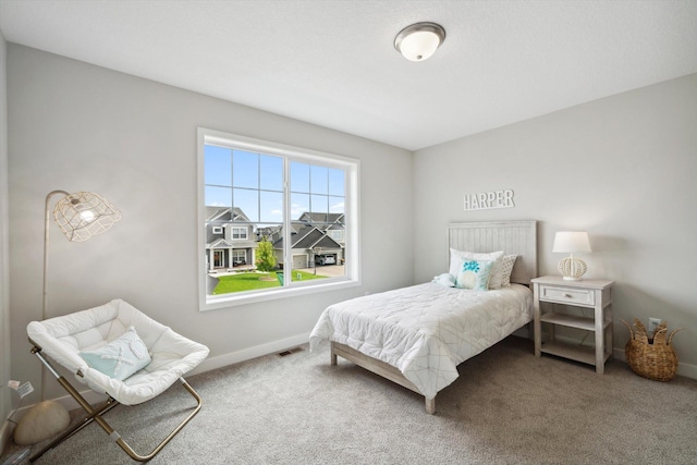 carpeted bedroom featuring baseboards and visible vents