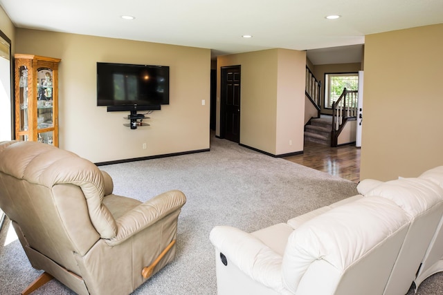 carpeted living area with baseboards, stairway, and recessed lighting