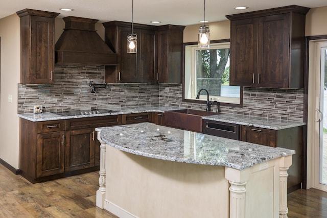 kitchen featuring dishwashing machine, black electric cooktop, dark wood-type flooring, a sink, and custom range hood