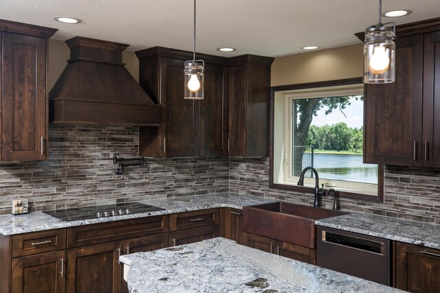 kitchen featuring dark brown cabinetry, custom range hood, black electric stovetop, stainless steel dishwasher, and a sink