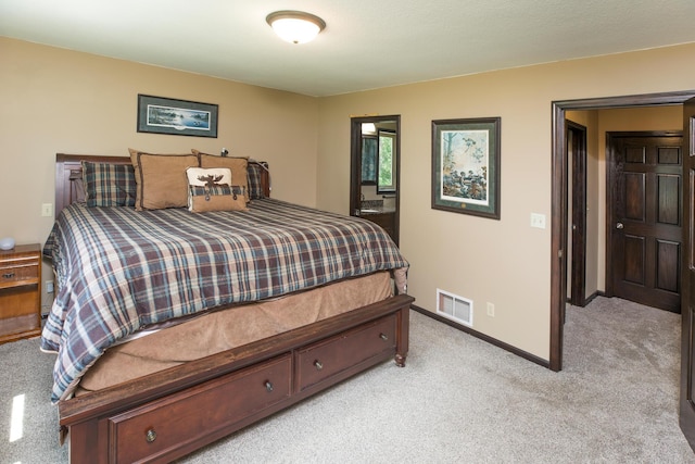 bedroom with light colored carpet, visible vents, and baseboards