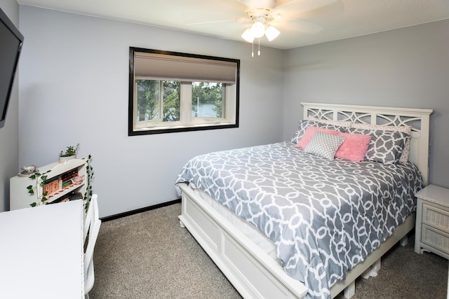 bedroom featuring light carpet, a ceiling fan, and baseboards