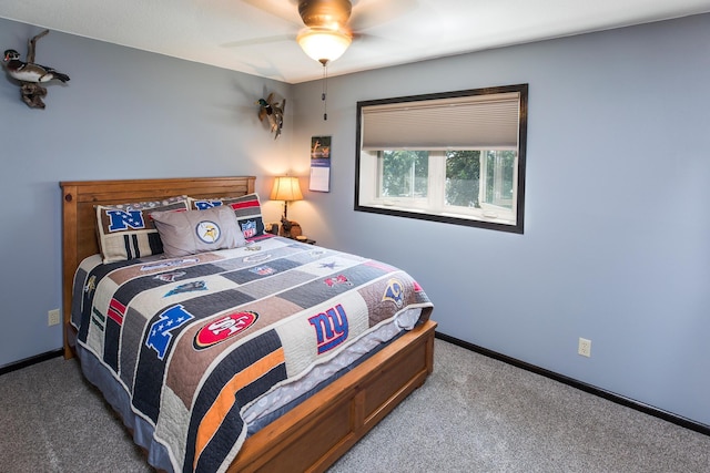 carpeted bedroom featuring ceiling fan and baseboards