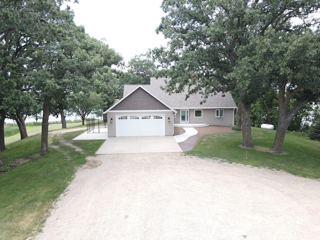 view of front of property with a garage, a front yard, driveway, and a shingled roof