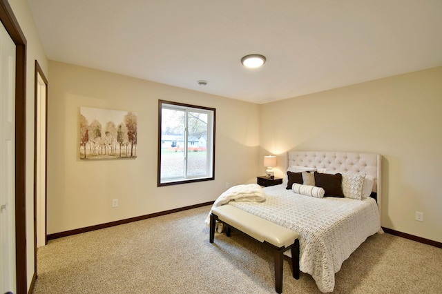 carpeted bedroom featuring baseboards