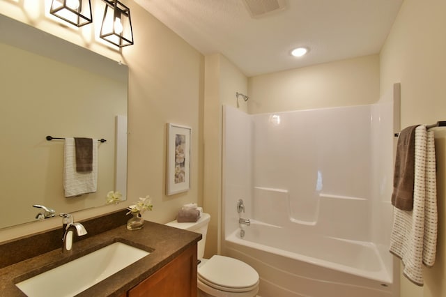 full bath with visible vents, vanity, toilet, and tub / shower combination