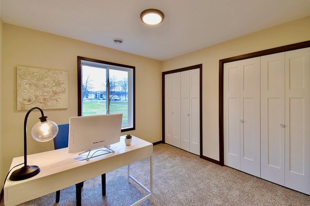 office area featuring light colored carpet and baseboards