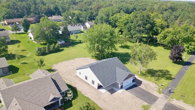 birds eye view of property with a wooded view