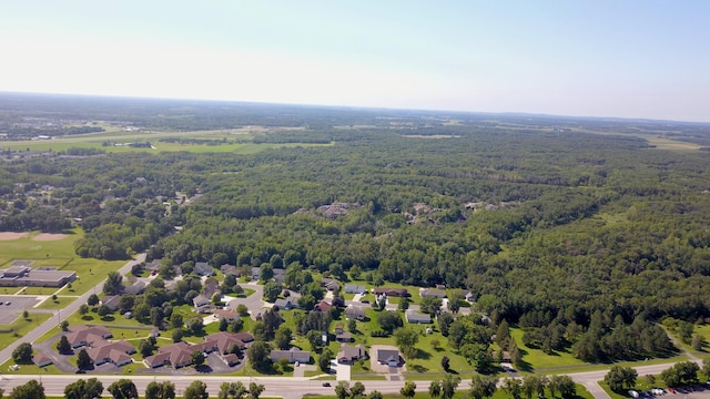 birds eye view of property featuring a view of trees