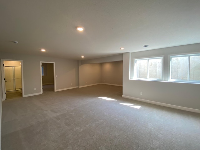 empty room with carpet, baseboards, and recessed lighting