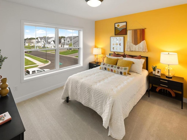bedroom featuring carpet and baseboards