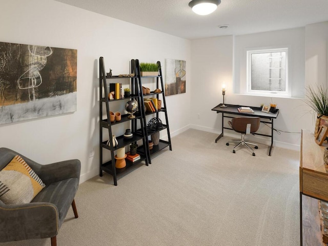 carpeted home office with baseboards