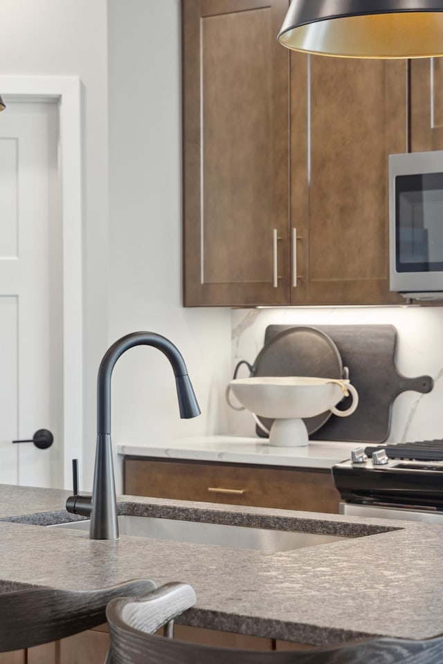 interior details with stainless steel microwave and a sink