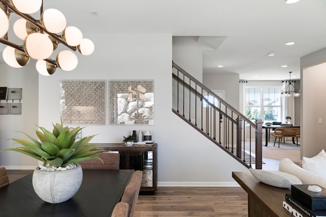 interior space with recessed lighting, baseboards, a notable chandelier, and wood finished floors