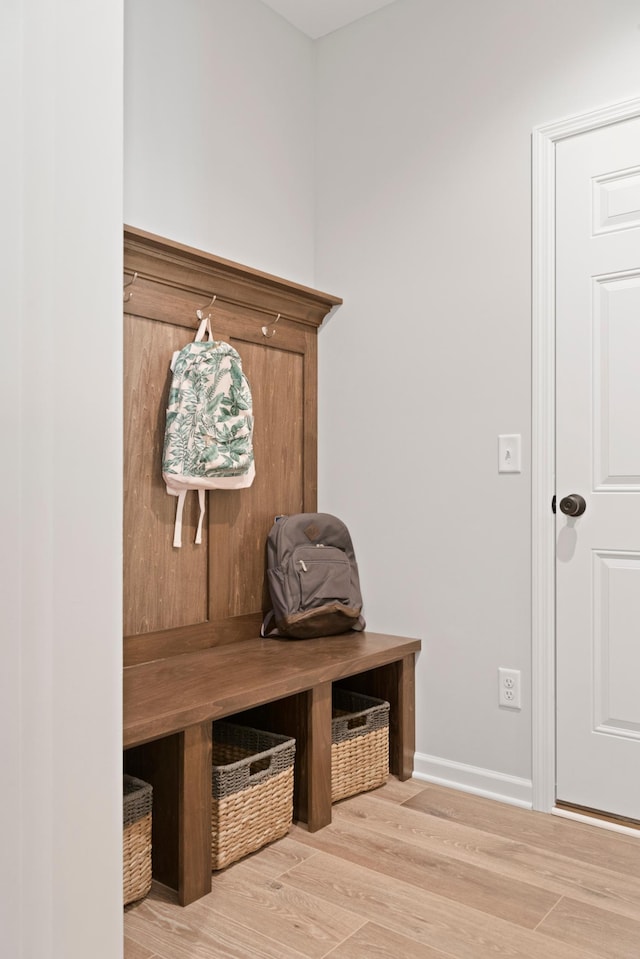 mudroom featuring baseboards and wood finished floors